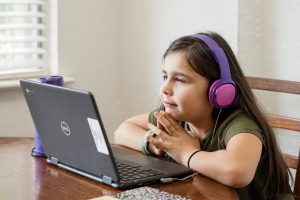 kid looking at computer